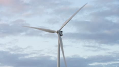 Frontal-Close-Up-To-Working-Windmill,-Cloudy-Backdrop