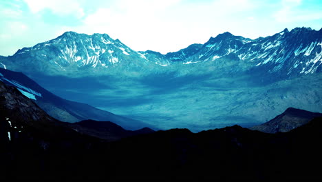 mountain gorge with green meadow illuminated by the sun