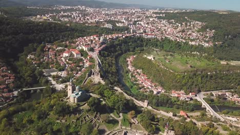 Seitliche-Drohnenaufnahme-Einer-Kirche-Auf-Einem-Hügel-Und-Der-Stadt-Veliko-Tarnovo