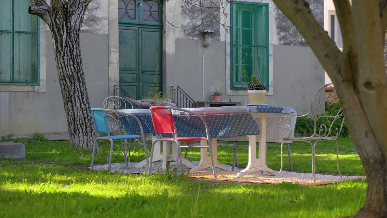 Slow orbiting shot of a garden table decorated with a table cloth for lunch
