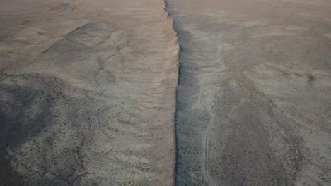 aerial over the rock formation spine connected to shiprock formation