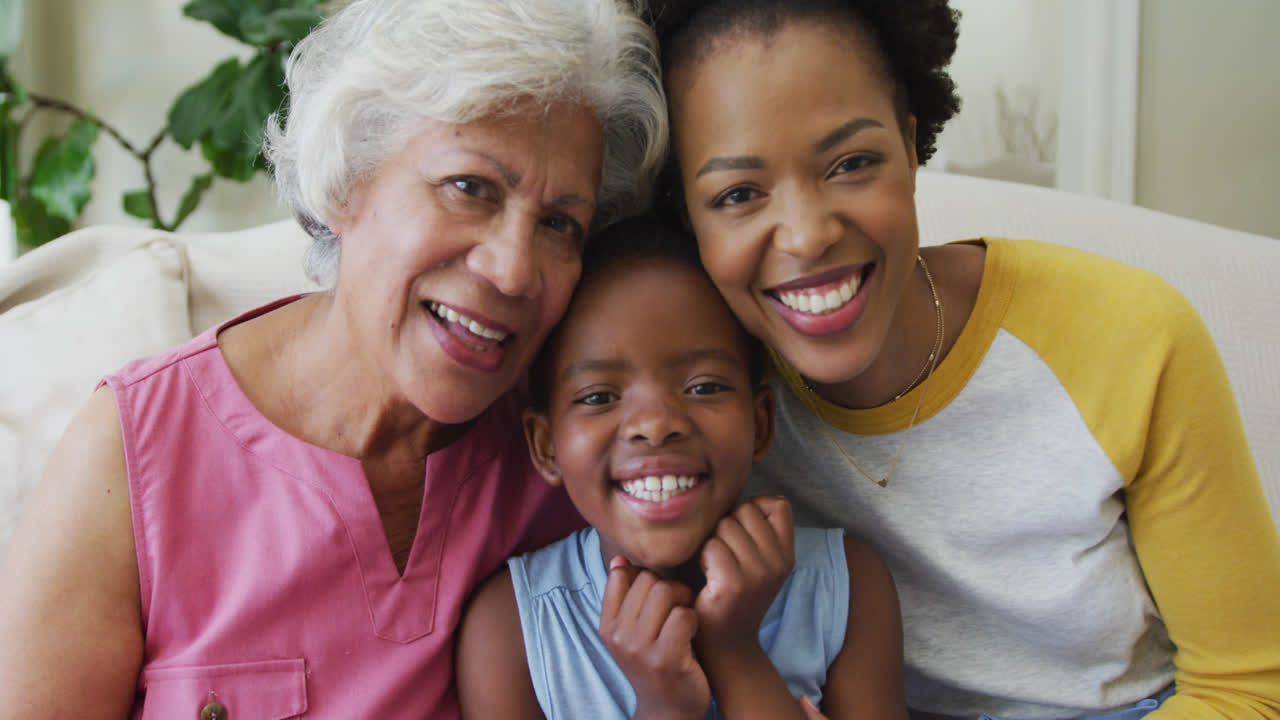 Portrait of happy african american grandmother with adult daughter and granddaughter