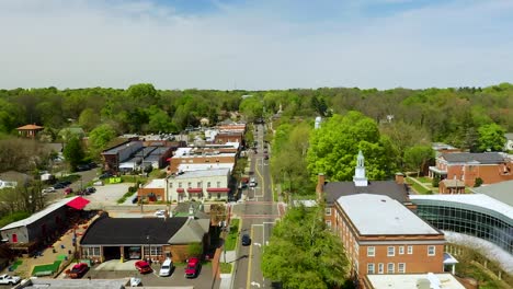 drone push in of small town usa downtown hillsboro north carolina in the summer