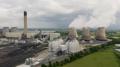 4k aerial footage of a coal fired power station with biofuel storage tanks