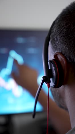 person analyzes financial data on screen with focus and concentration
