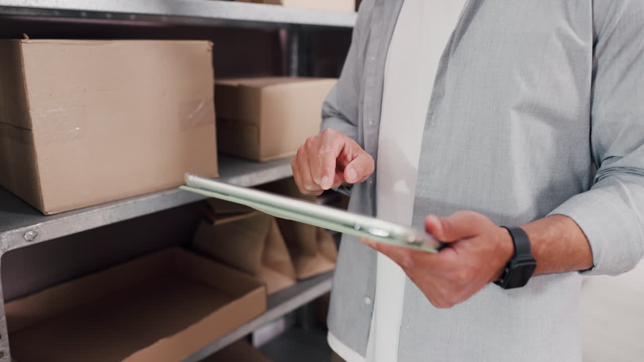 Person Using Digital Tablet to Check Inventory in Warehouse