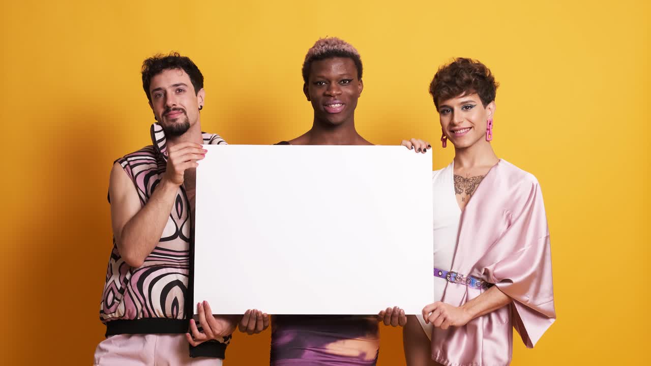 Multiracial group of transgender men holding a white panel