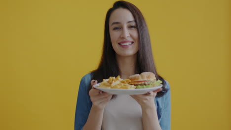 woman enjoying a burger and fries