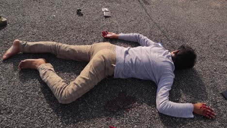 crime scene concept, establishing shot of dead body laying on road at hot sunny day