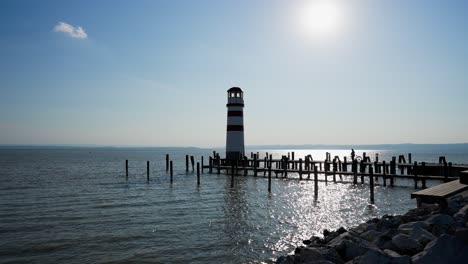 lighthouse under the sun, lake neusiedler see, podersdorf, austria, wide shot