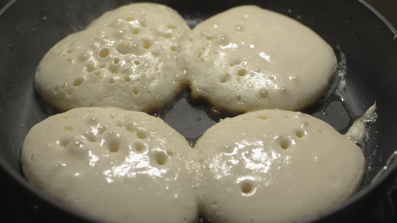 Pancakes Put And Cooked In The Frying Pan For Snacks Time - Close Up Shot