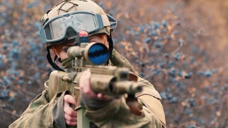 a woman in camouflage aims with a rifle 2