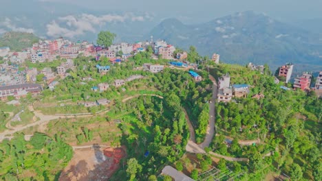drone video captures the stunning manakamana hill in gorkha, nepal—home to the sacred hindu temple, surrounded by dramatic hilltop views, traditional villages, and a famous cable car route.