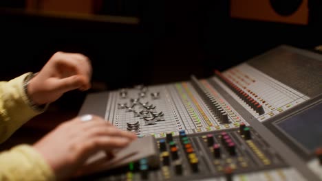 audio engineer working on mixing board