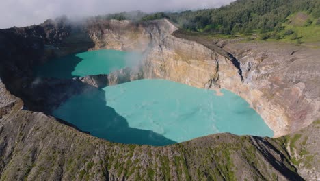 Aerial-drone-shot-of-the-volcanic-crater-of-the-Kelimutu-Volcano-at-Flores-Island,-Indonesia