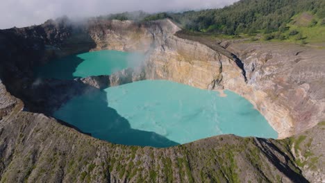 aerial drone shot of the volcanic crater of the kelimutu volcano at flores island, indonesia