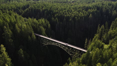 Aerial-view-tilting-over-a-car-crossing-the-High-Steel-Bridge,-in-Washington,-USA