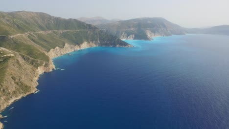 retreating drone shot moving overhead above the coast of the peninsula of agriosiko beach located in the island of cephalonia in western greece