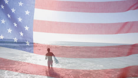 animation of american flag over biracial man with surfboard walking into sunny sea