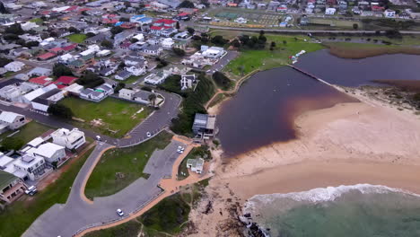 tanin rich lagoon and kleinmond coastal town next to mountain