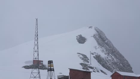 Research-Station-Base-on-Coast-of-Antarctica,-Buildings-and-Tower-on-Snowy-Day