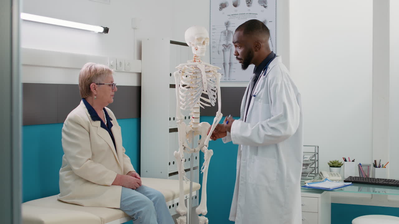 Doctor explaining diagnosis to patient with skeleton model
