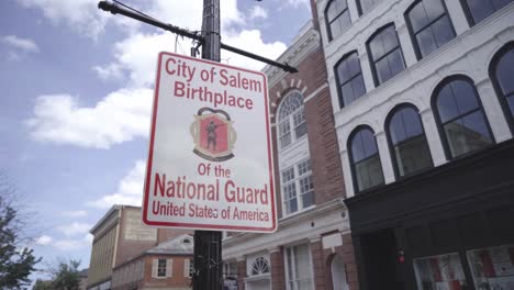 Wide-static-shot-of-a-street-sign-in-Salem,-Massachusetts-marking-the-birthplace-of-the-United-States-National-Guard