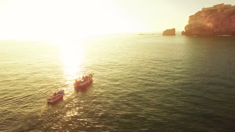 sunset fishing boats at coastline
