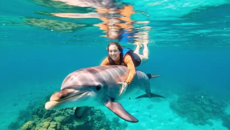 a joyful encounter beneath the waves: a diver interacts with a playful dolphin in crystal clear waters, showcasing nature's beauty and marine life
