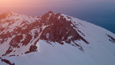 sunrise or sunset over snowy mountain peaks