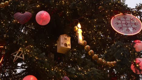 giant hand made ornaments and candles in town square christmas tree at festive christmas market in strasbourg, france europe