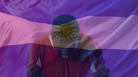 animation of flag of argentina over african american male soccer player