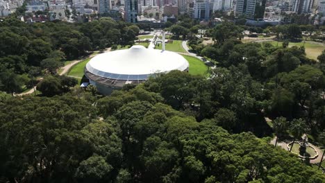 aerial drone fly above parque da redenção porto alegre araujo vianna auditorium in daylight, brazilian farroupilha park