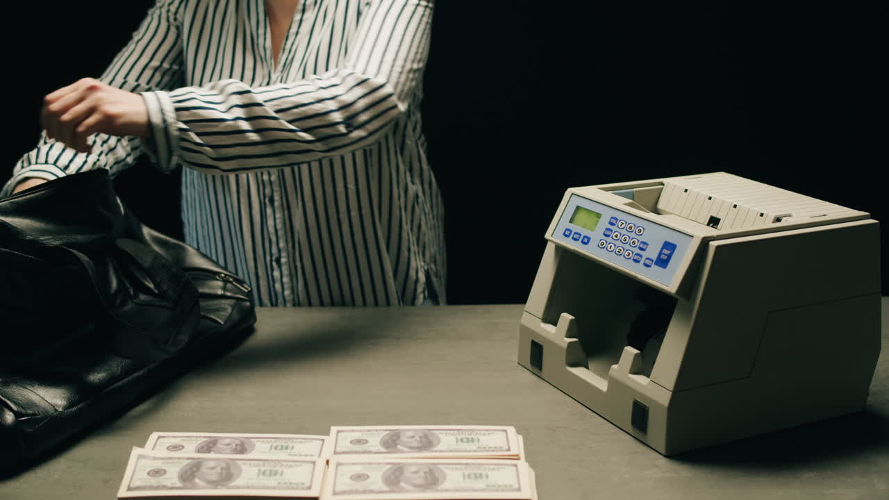 Specialised police officer Counting dollar banknotes in crime lab, conceptual image. High quality 4k footage