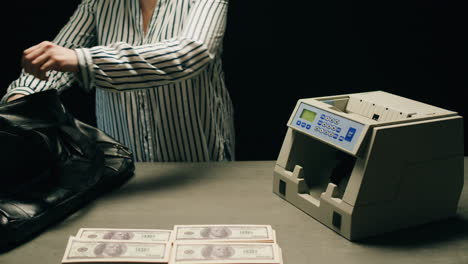 specialised police officer counting dollar banknotes in crime lab, conceptual image. high quality 4k footage