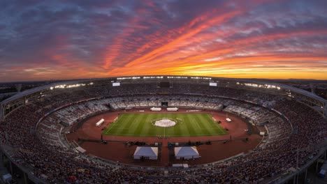 Stunning Sunset Over an Energetic Stadium Packed with Spectators, the Drama of Competition Unfolds Below as the Day Transitions to Night