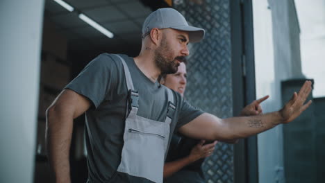 logistics team discussing work by a delivery truck