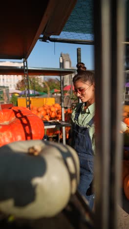 woman shopping for pumpkins at a fall market