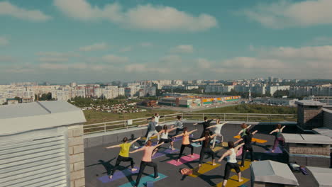 group yoga session on rooftop with city view