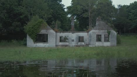 derelict bungalow house sits on river shoreline