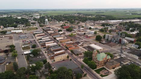 aerial view of rural small town with small business and houses in the late evening, cornfields in background