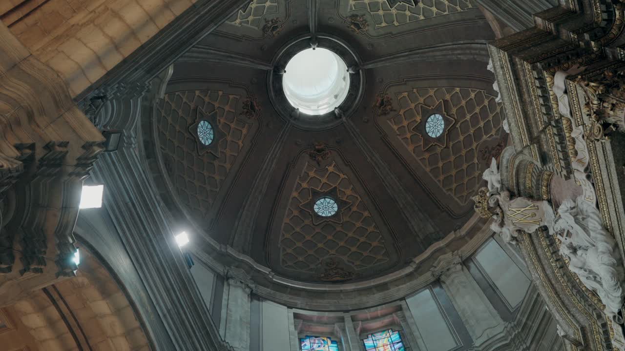 detailed ceiling with intricate patterns and small stained glass windows, showcasing ornate architecture