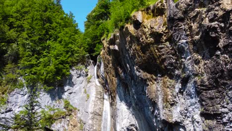 Aerial-Tilting-Shot-of-Berglistüber-Waterfall-in-Swiss-Alps-in-Switzerland