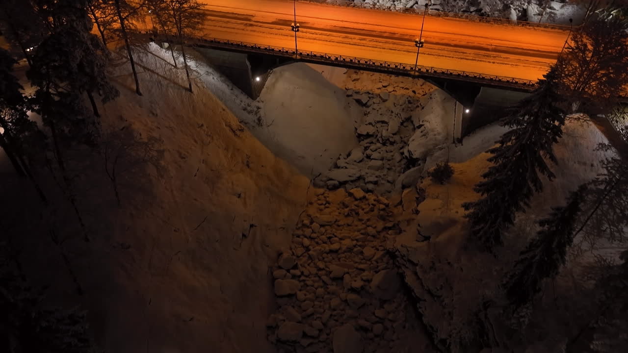Aerial tilt shot toward the Imatrankoski dam, winter evening in Imatra, Finland