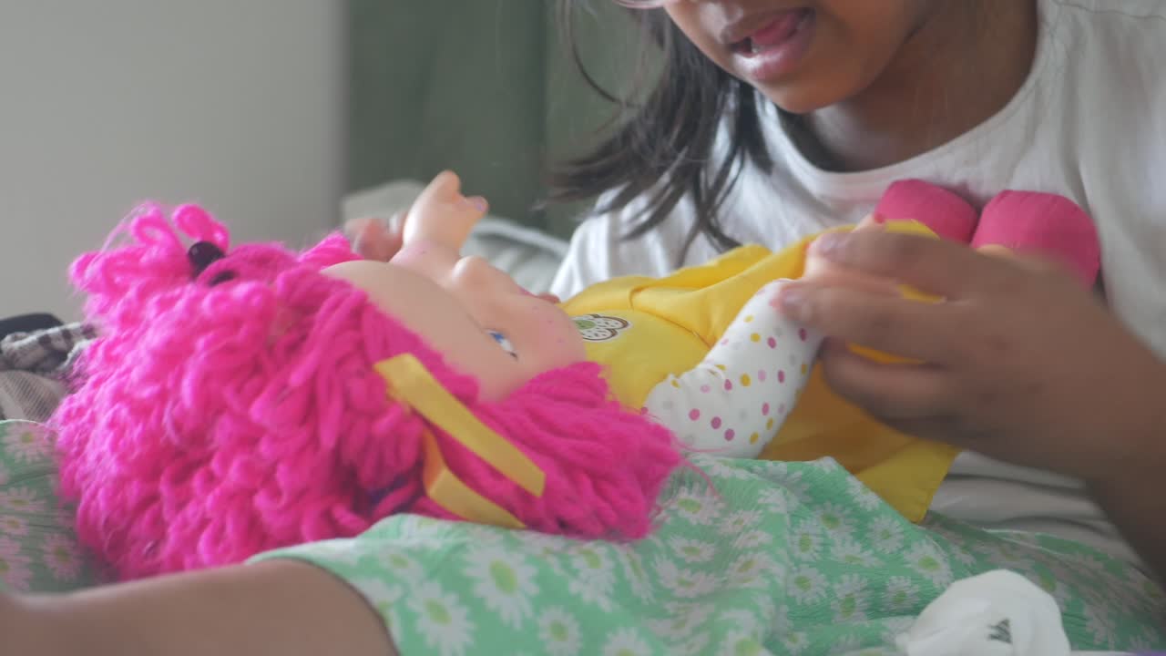 Girl playing with a doll