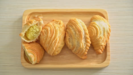 curry puff pastry stuffed beans on wooden plate