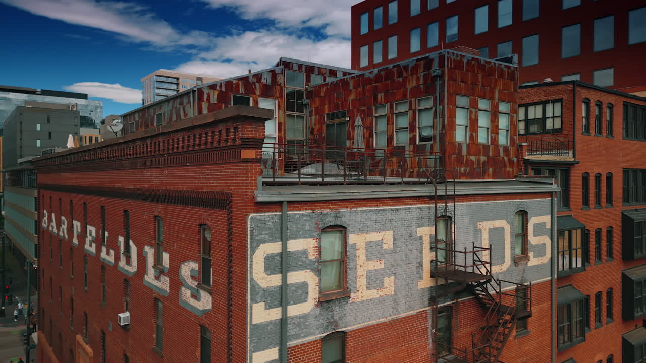 Denver, USA, 28 July 2025: Flying around red brick building with annexes on the rooftop. Old structures of Denver, Colorado, USA