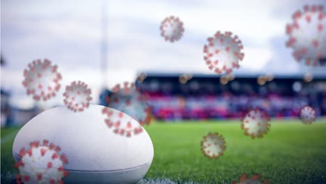 Covid-19-cells-against-rugby-ball-on-sports-field