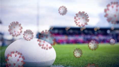 covid-19 cells against rugby ball on sports field
