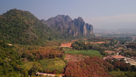 aerial view of mountains, valley, and village in laos